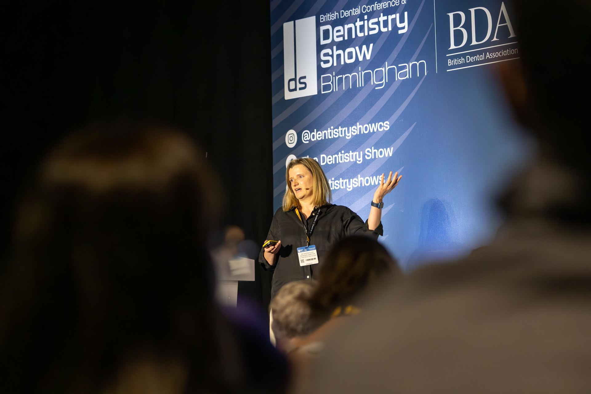 Speaker on stage at a dental conference